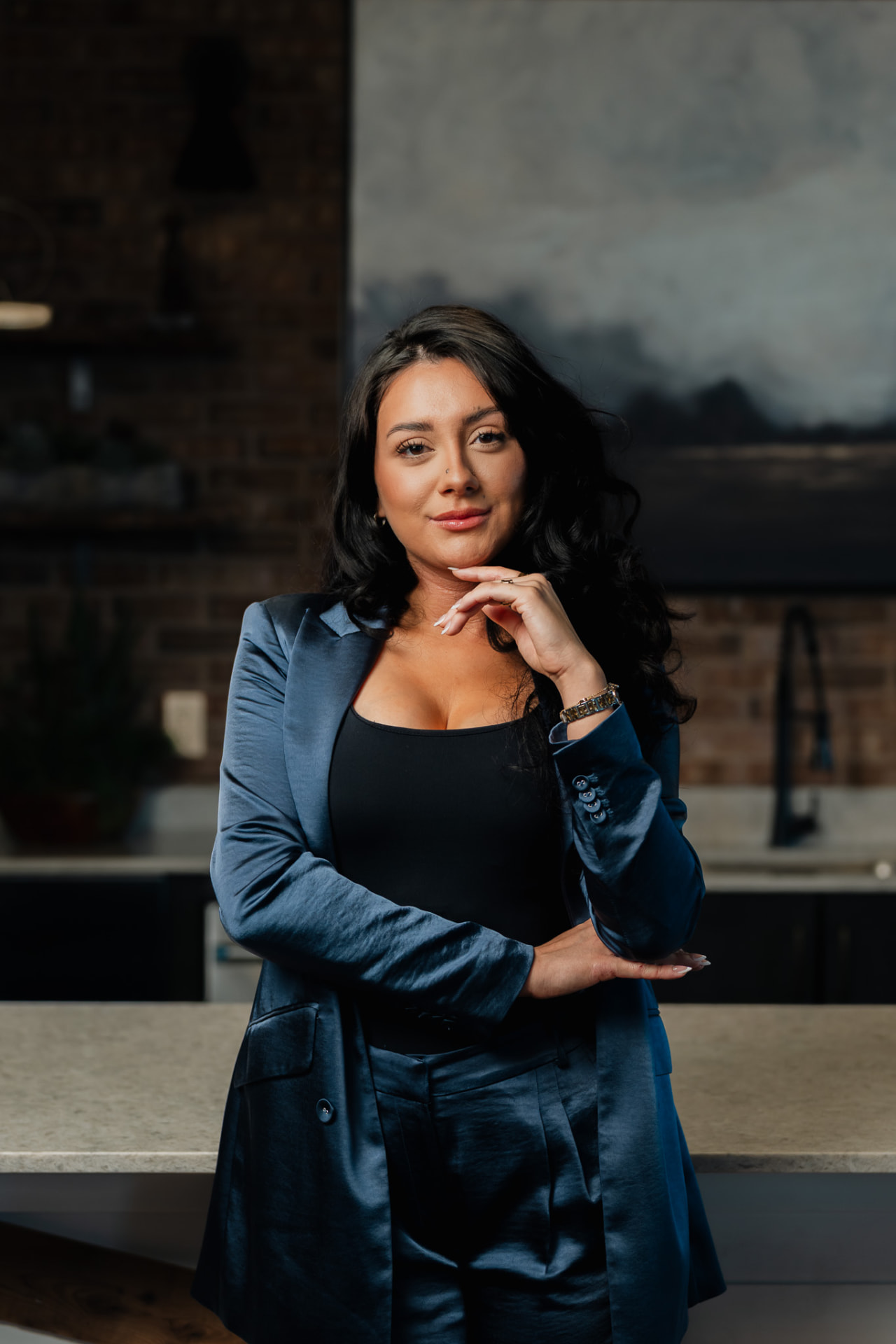 Brand portrait in a navy suit inside a modern kitchen