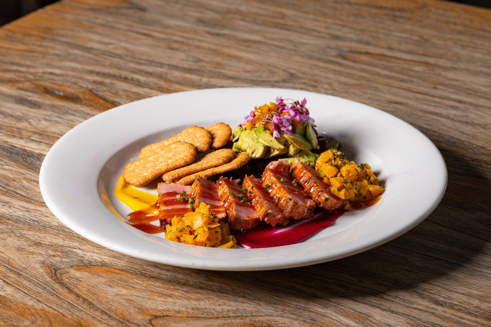 Seared tuna with mango salsa, avocado, and crackers