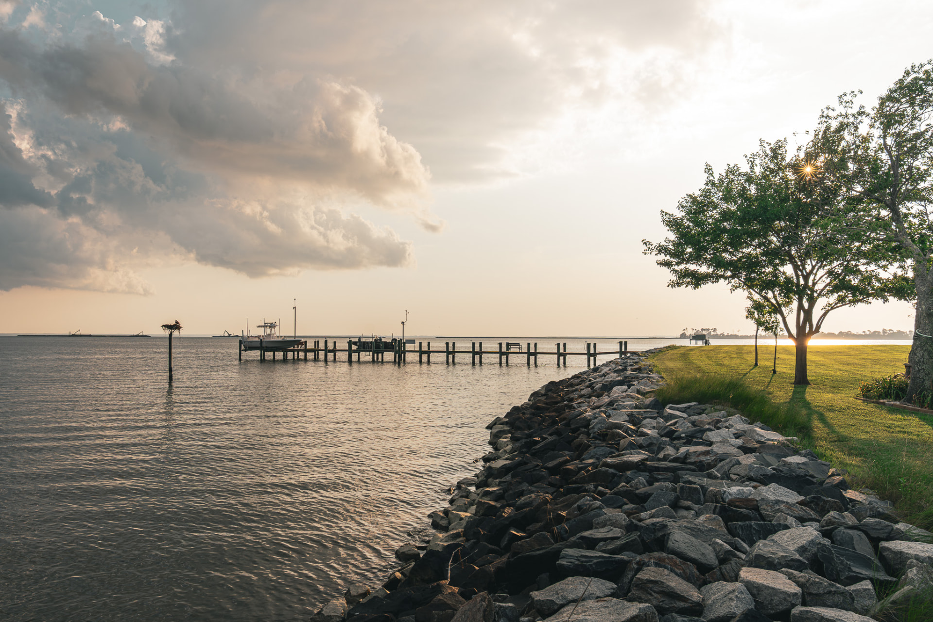 Pier and riprap shoreline at golden hour on the bay