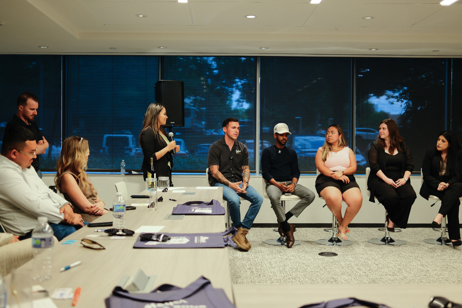 Panel discussion in a conference room with seated guests
