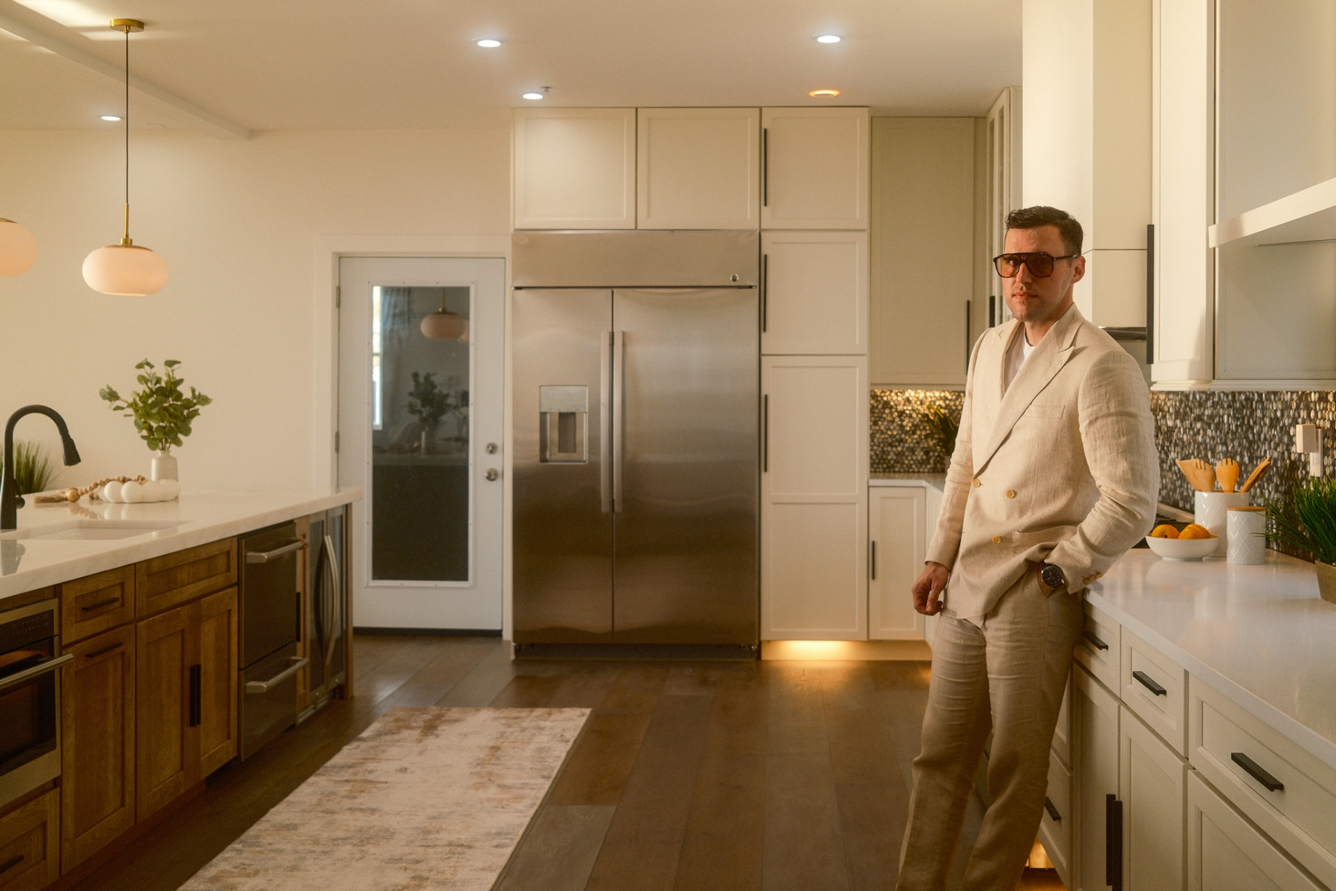 Lifestyle brand portrait in a linen suit in a bright kitchen