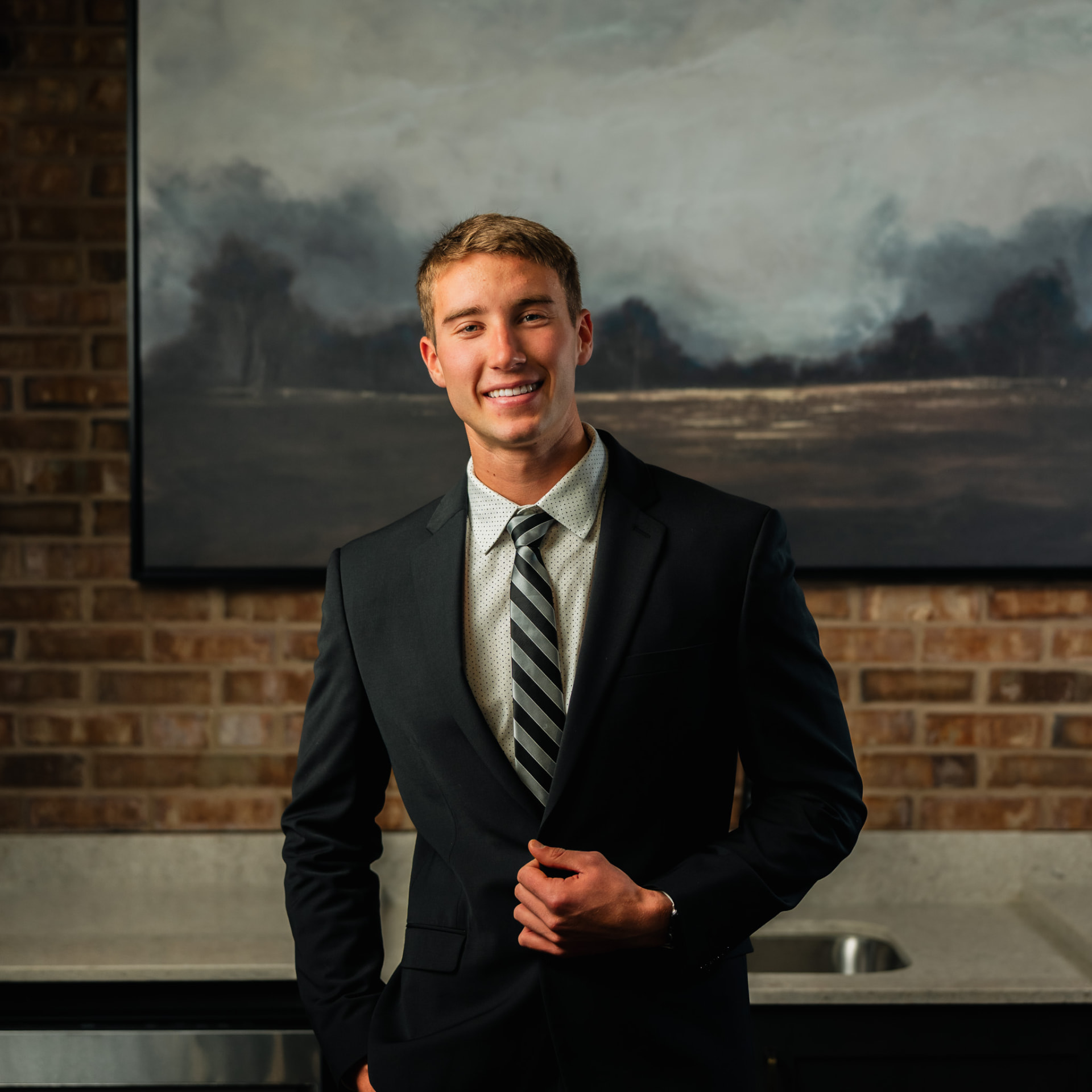 Real estate agent headshot against exposed brick