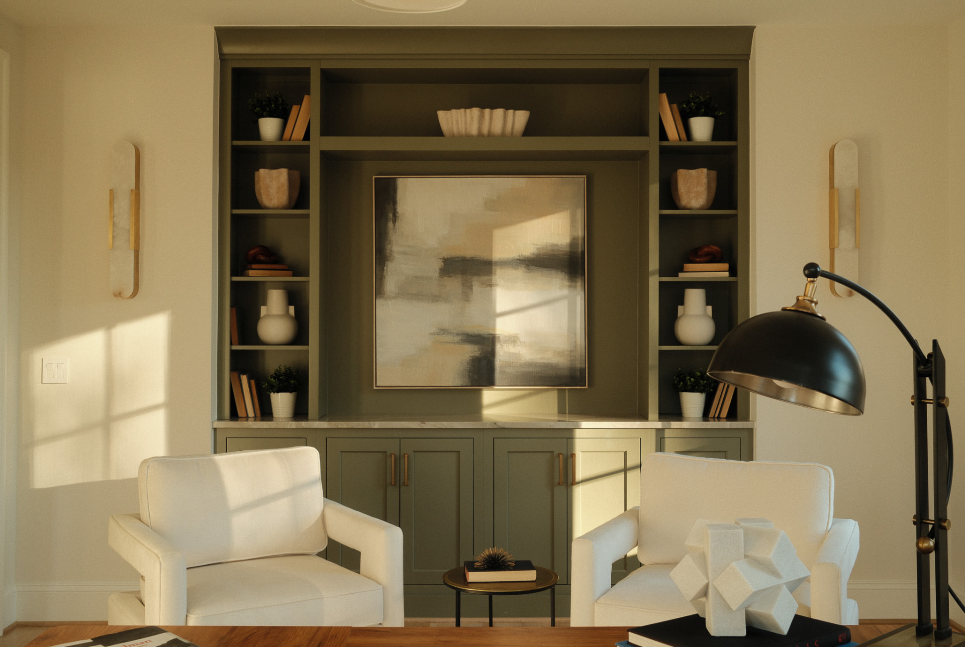 Living room with olive green built-in shelving and armchairs
