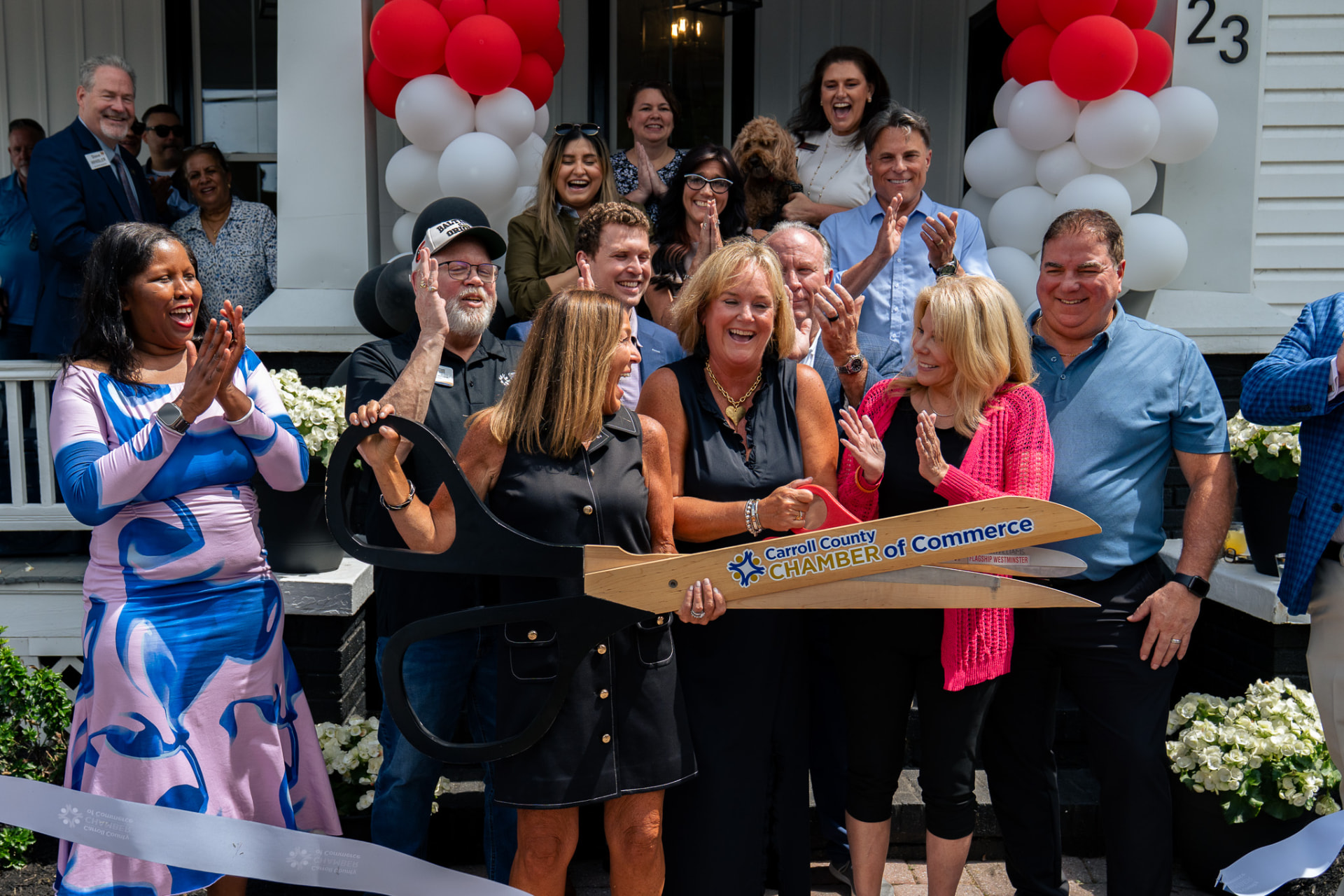 Chamber of commerce ribbon cutting ceremony with a large crowd