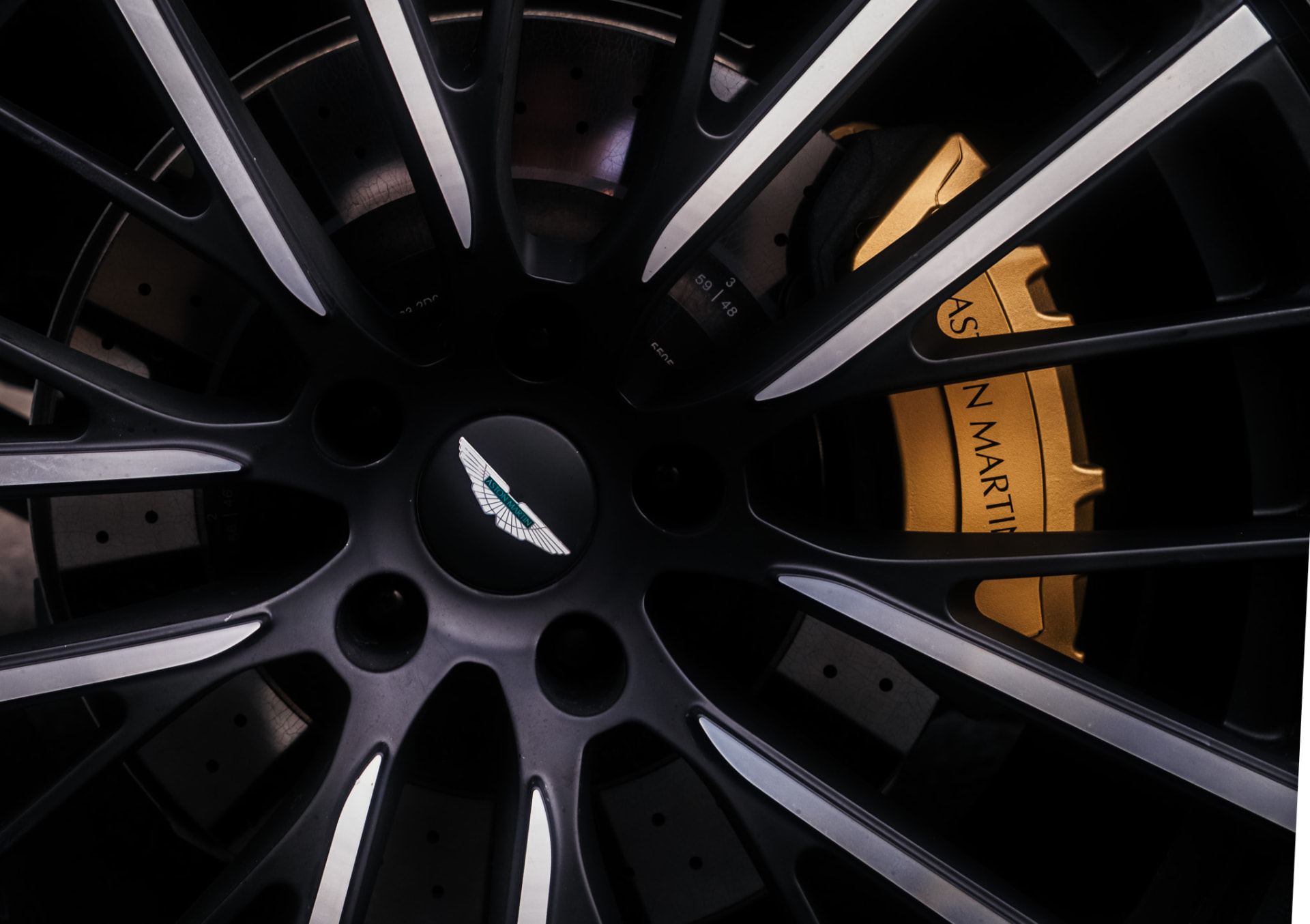 Aston Martin wheel detail with gold brake caliper