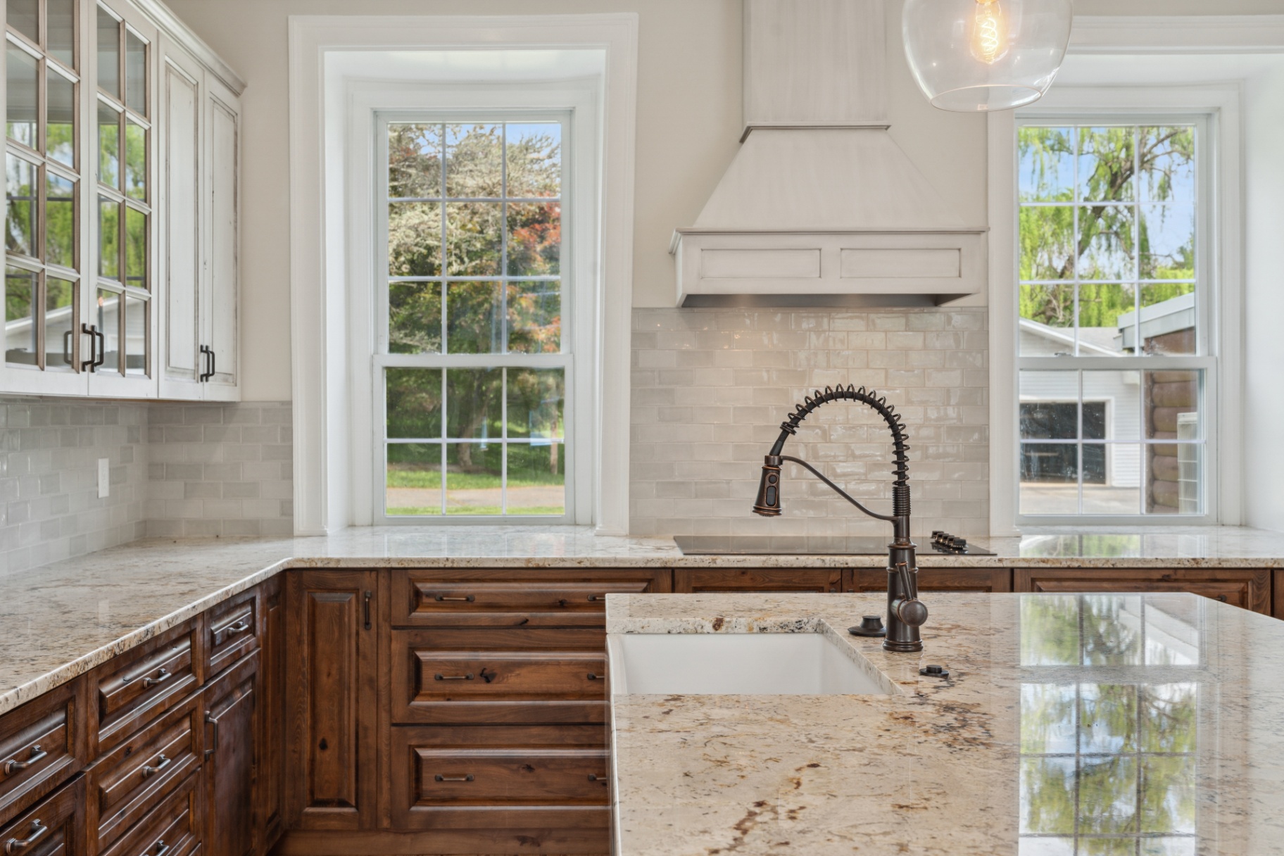 Bright kitchen with granite counters and bay window